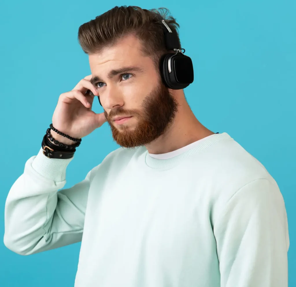 portrait stylish attractive young bearded man listening music wireless headphones modern style confident mood scaled e1767558906104